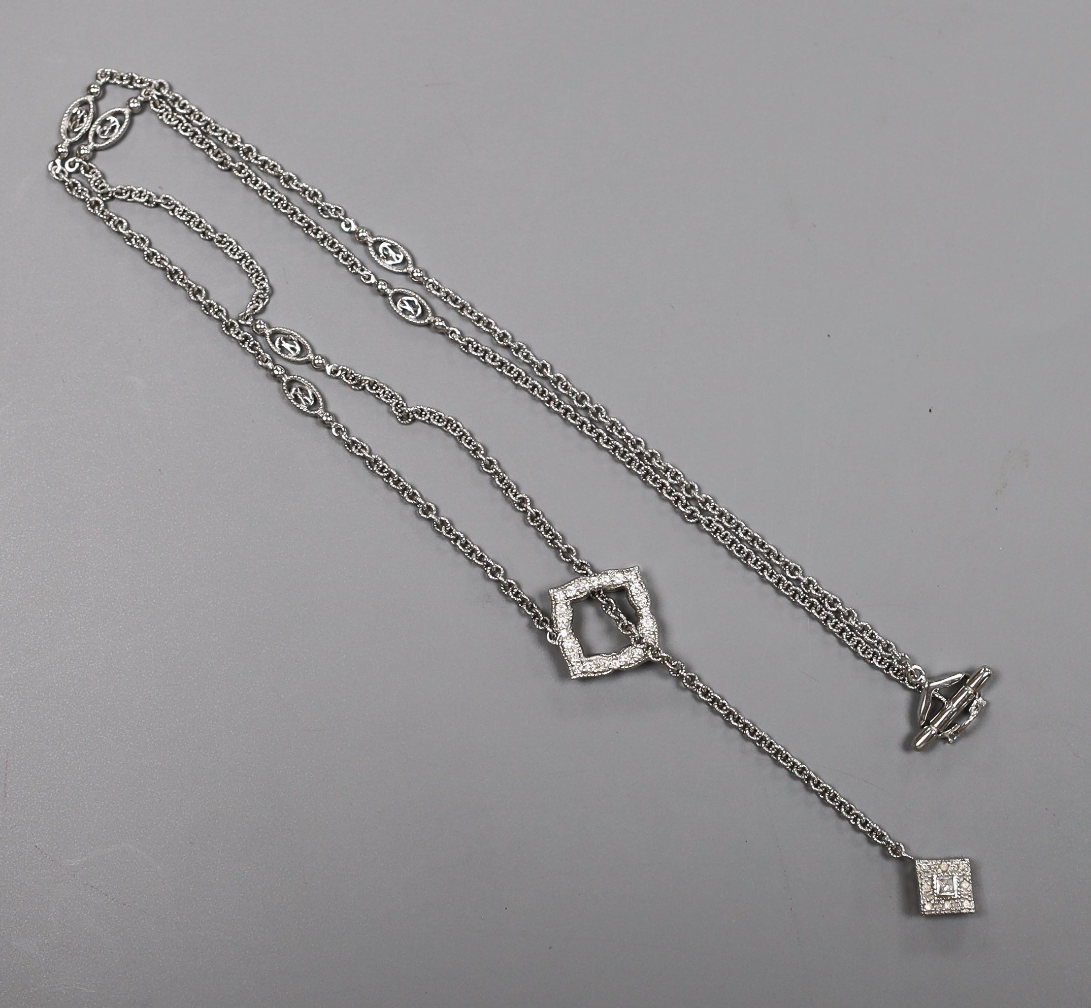 A modern 750 white metal and diamond cluster set drop necklace, 54cm, gross weight 10 grams.